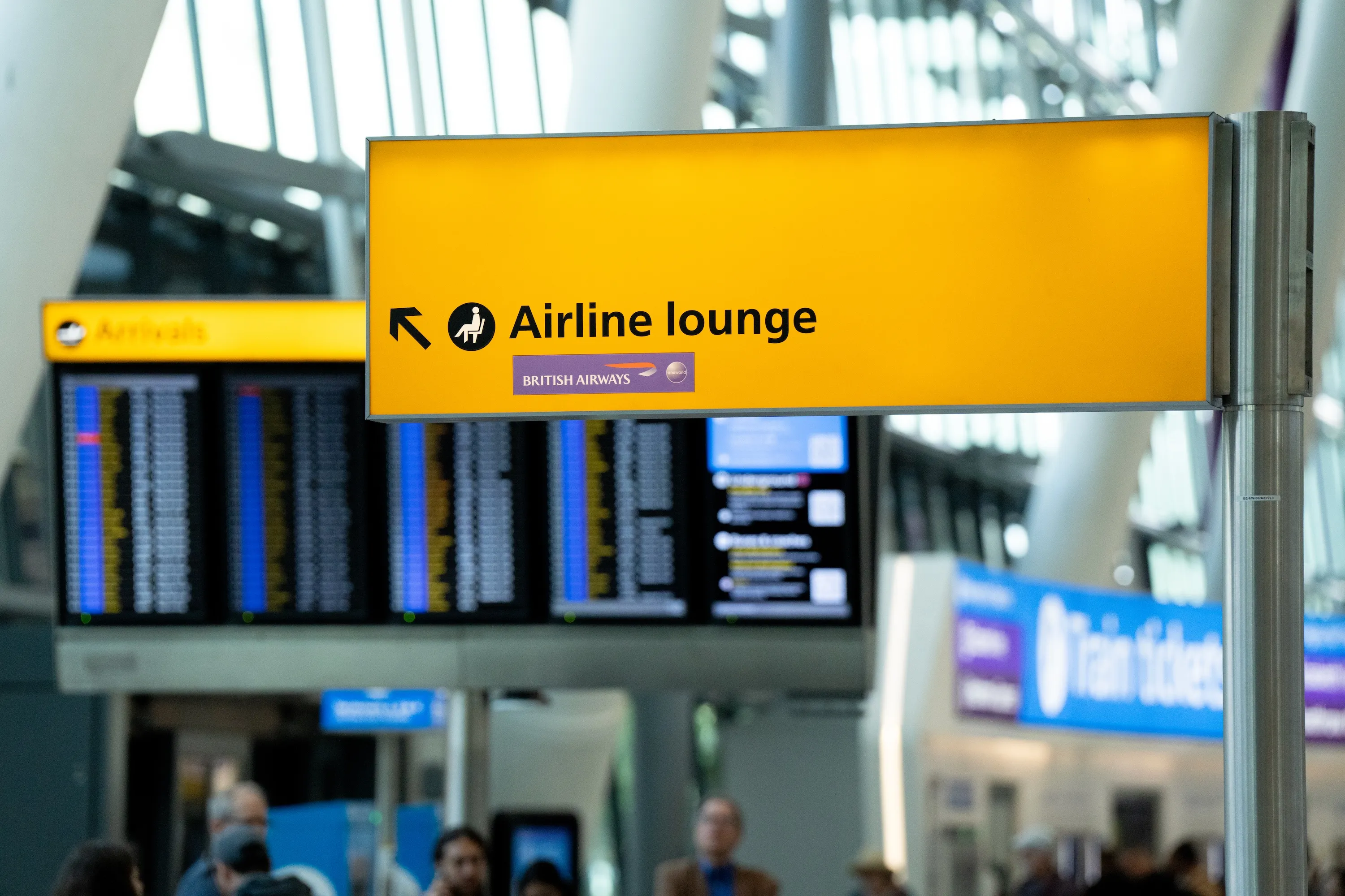 An airport sign pointing to the British Airways lounge, a real-world journey touchpoint the app mirrors